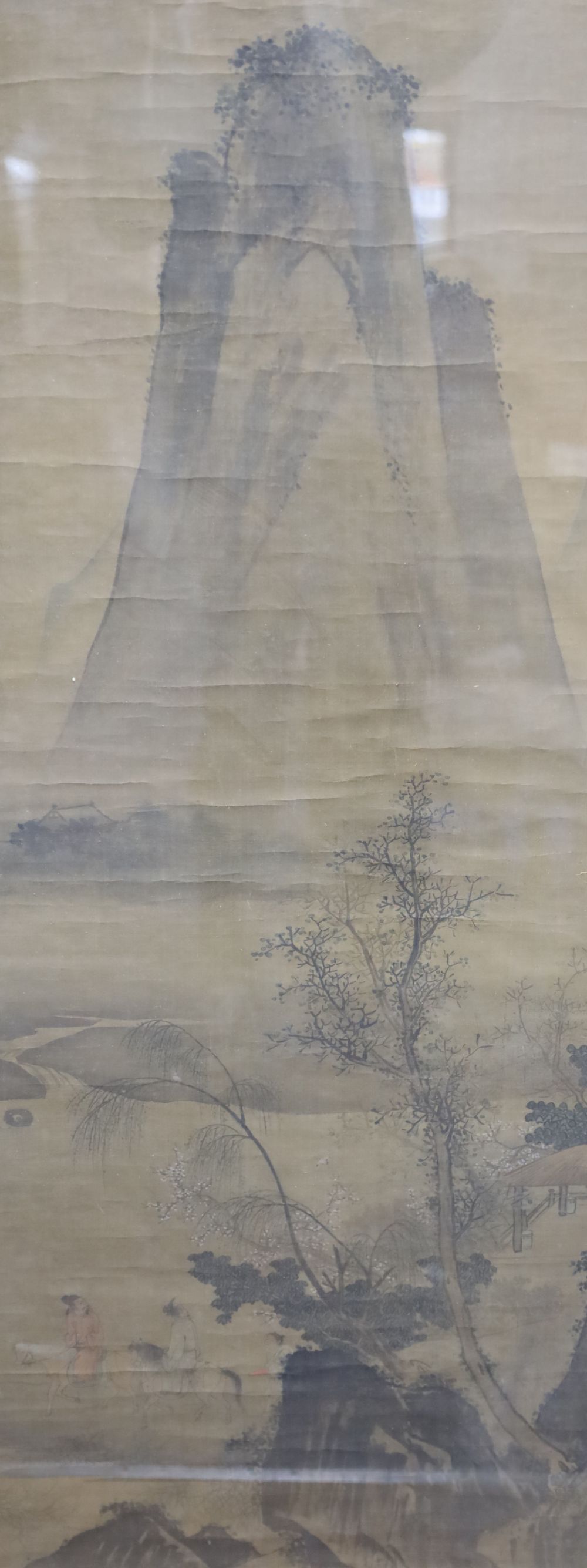 A Chinese watercolour on silk, Travellers passing a mountain peak, 120 x 48cm